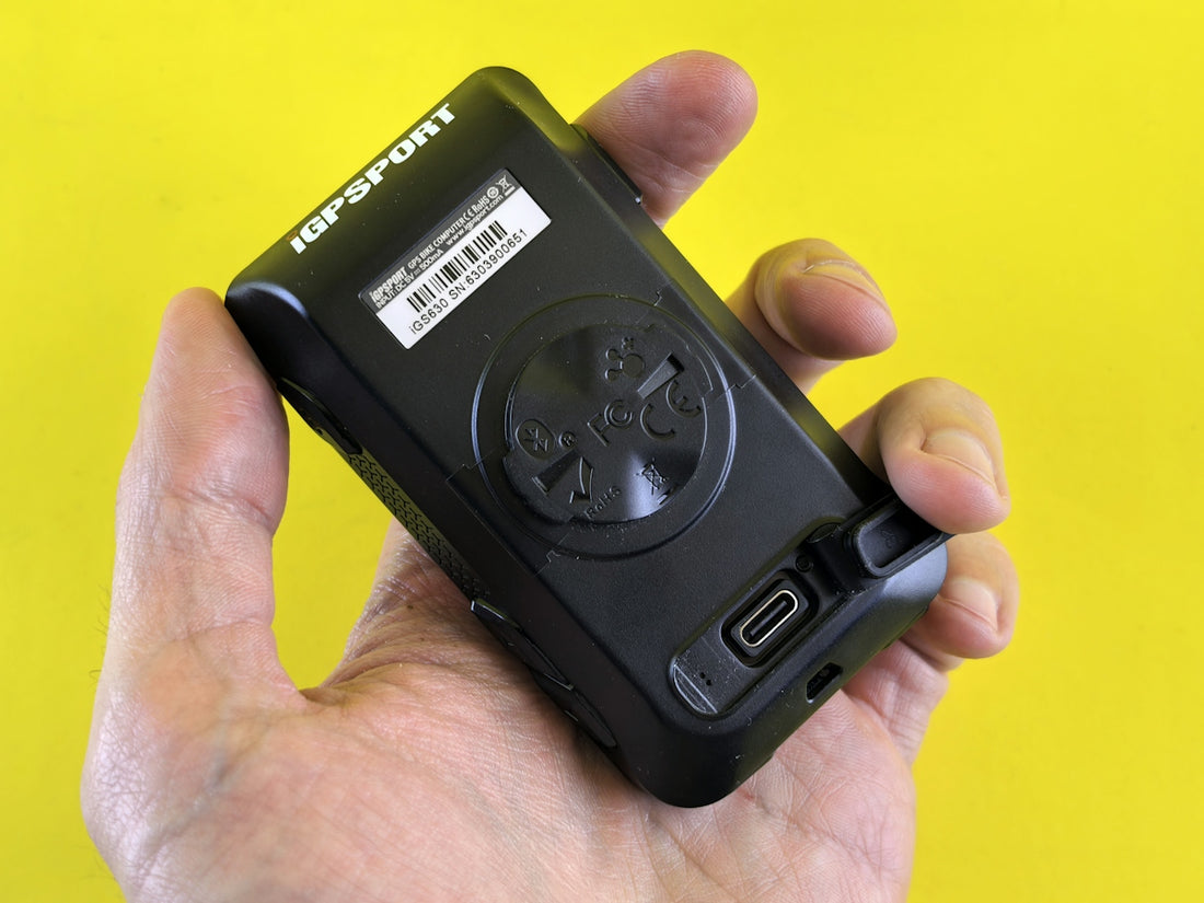 Hand holding a small black electronic device