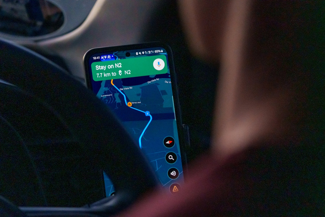Person using navigation app on smartphone inside car